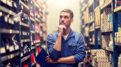 auto mechanic with clipboard at car workshop