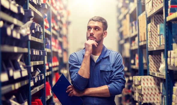 auto mechanic with clipboard at car workshop