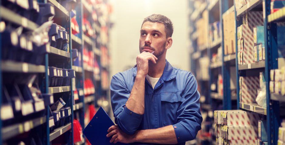 auto mechanic with clipboard at car workshop