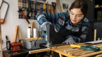 female-working-workshop-with-hammer-drill