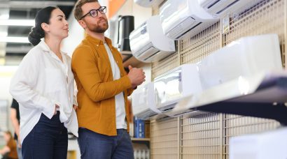 Young couple, satisfied customers choosing air conditioner in appliances store
