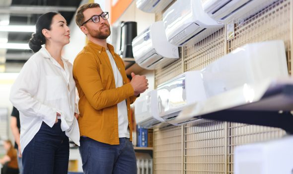 Young couple, satisfied customers choosing air conditioner in appliances store