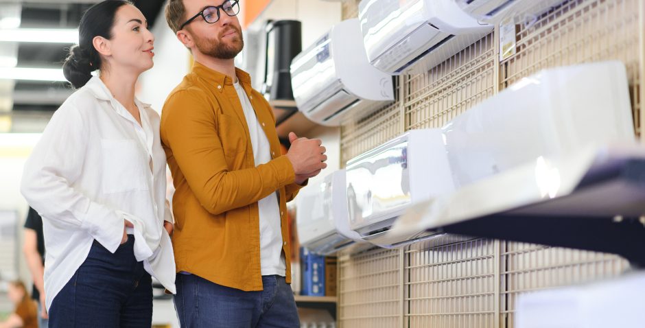 Young couple, satisfied customers choosing air conditioner in appliances store
